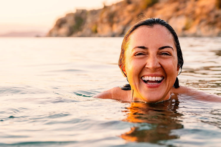 midlife women swimming in beautiful area - smiling and joyful