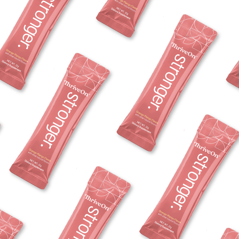 Multiple pink 'ThriveOn Stronger' packets arranged on a white background